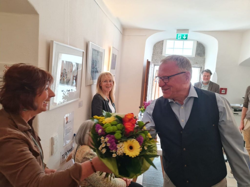 1. Vorsitzender Peter Wunder begrüßte die neue Werkschau-1kuratorin Tanja Lennert mit einem Blumenstrauß.